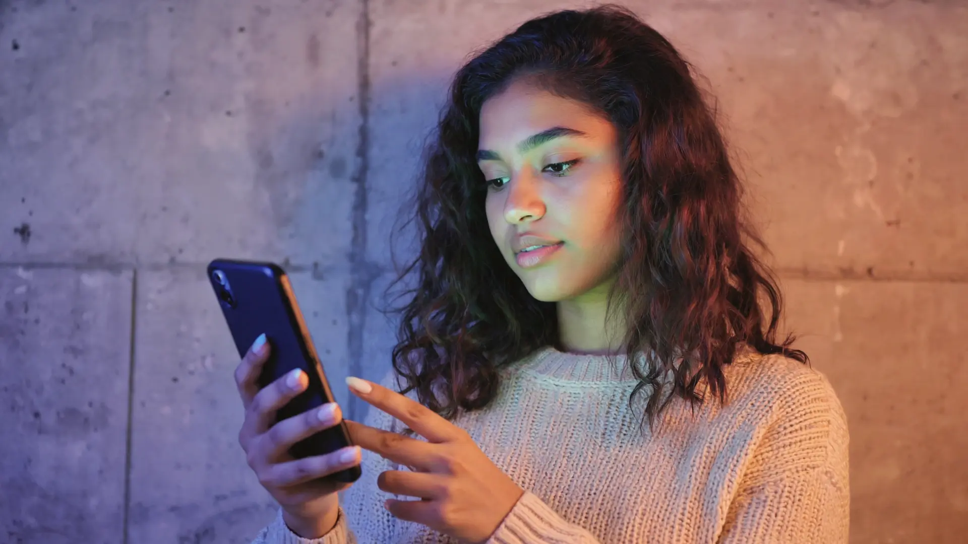 Person scrolling on a smartphone, illustrating mobile-first discovery and how people decide what to watch