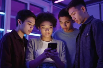 Children scrolling on a smartphone, illustrating mobile-first discovery and how audiences now choose streaming content