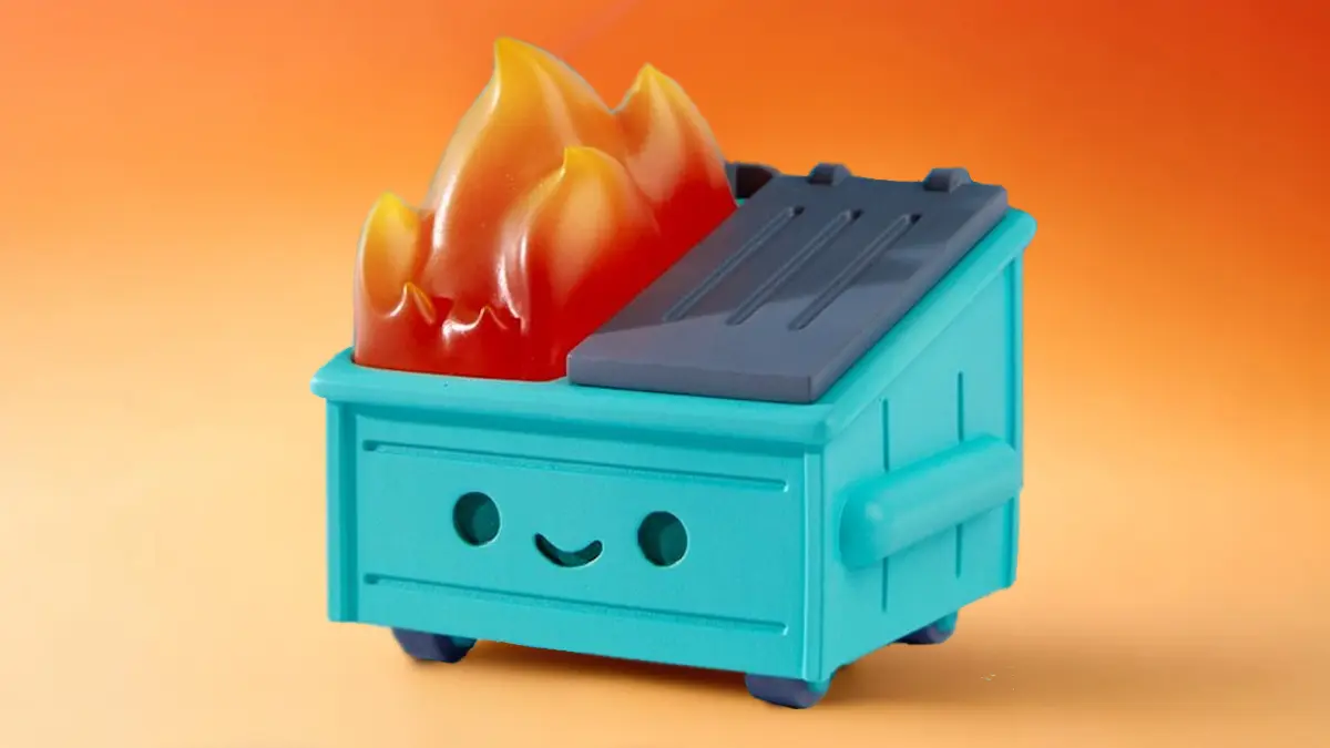 Dumpster Fire toy collectible with flames on top against orange background