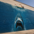 Hand-painted shark mural on a brick wall, inspired by the practical artistry of classic filmmaking.