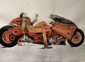 Original Akira artwork depicting Kaneda beside his futuristic motorcycle, on display at the Lucas Museum of Narrative Art.