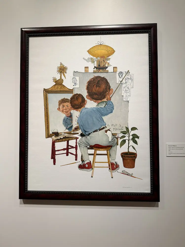 MAD Magazine illustration showing a boy painting a self-portrait, displayed at the Lucas Museum of Narrative Art.